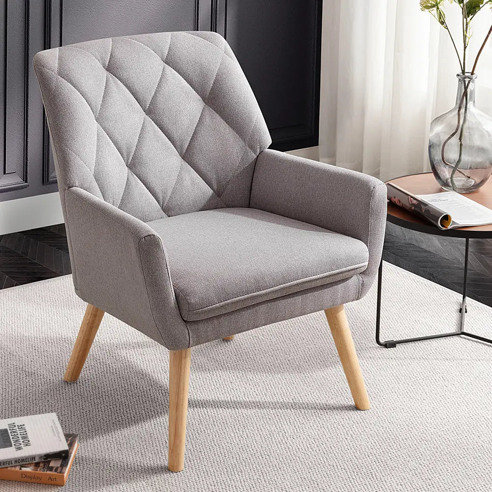 Close-up of plush cushions and curved armrests on the Camila armchair