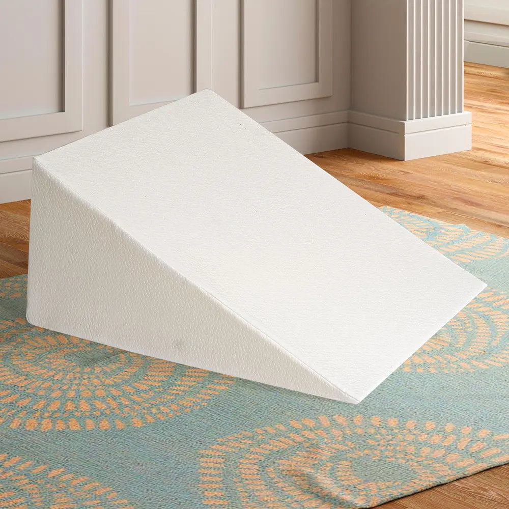 Kori wedge pillow in a cozy bedroom setting