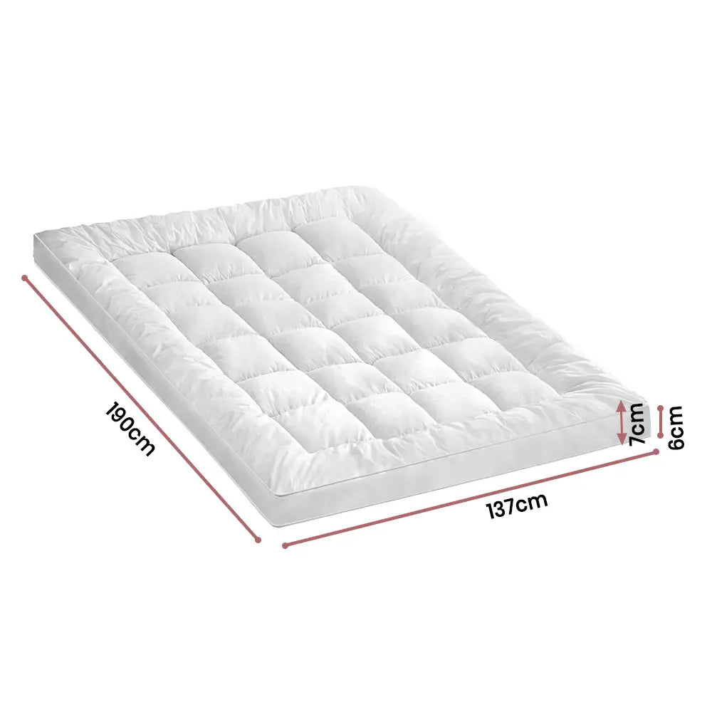 Comfortable and breathable Zoilo Mattress Topper in a bright, airy room