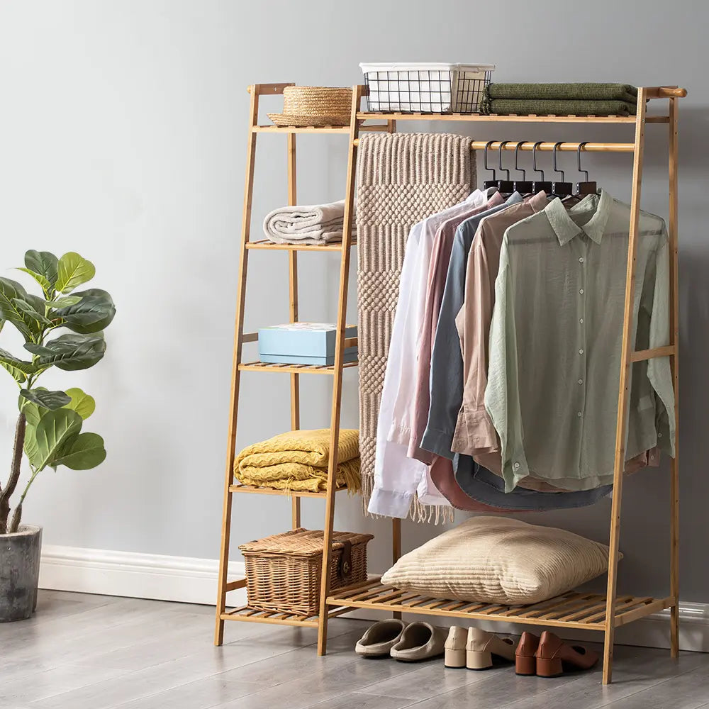 Natural wood Billy garment rack holding dresses and accessories