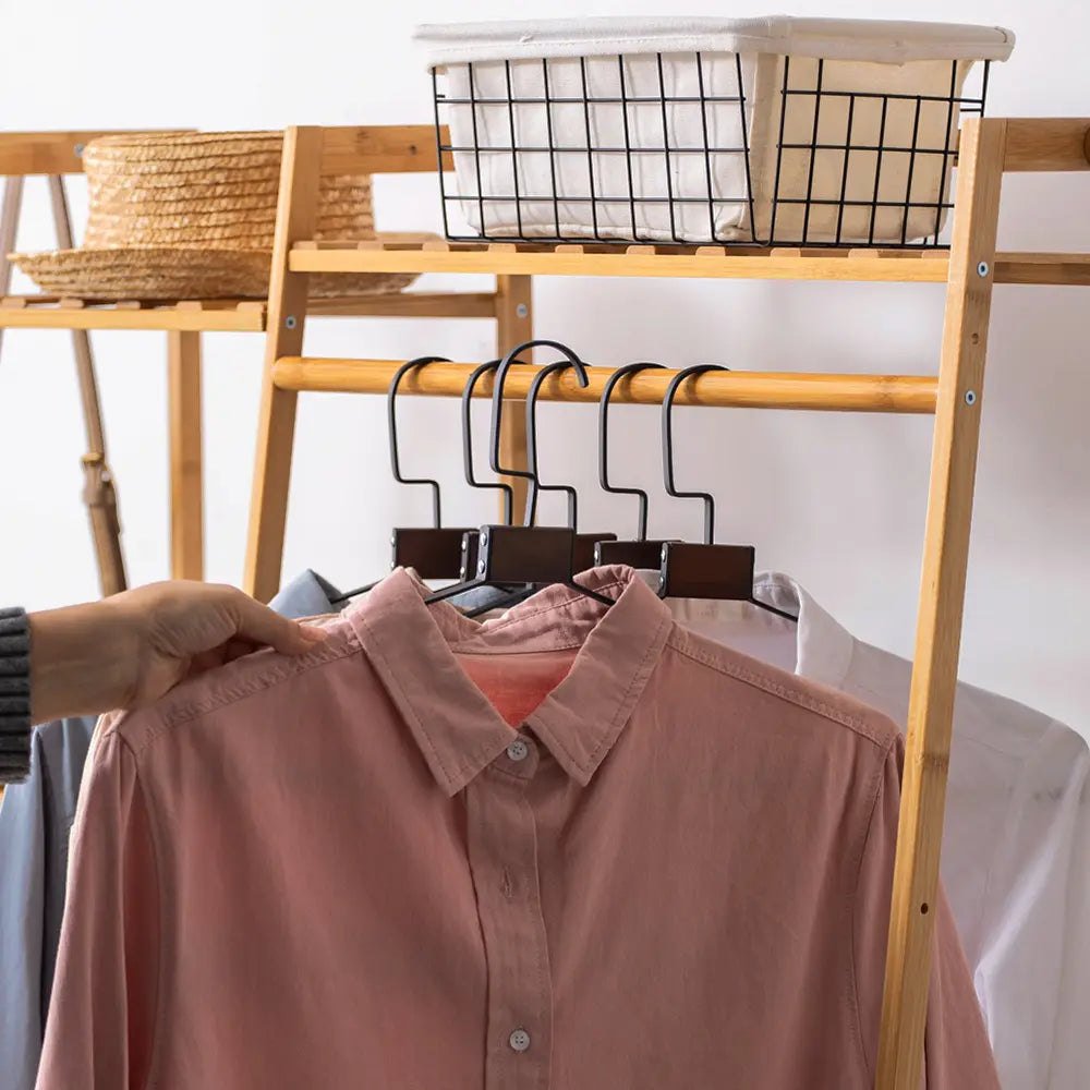 Billy Wooden Garment Rack against a white wall