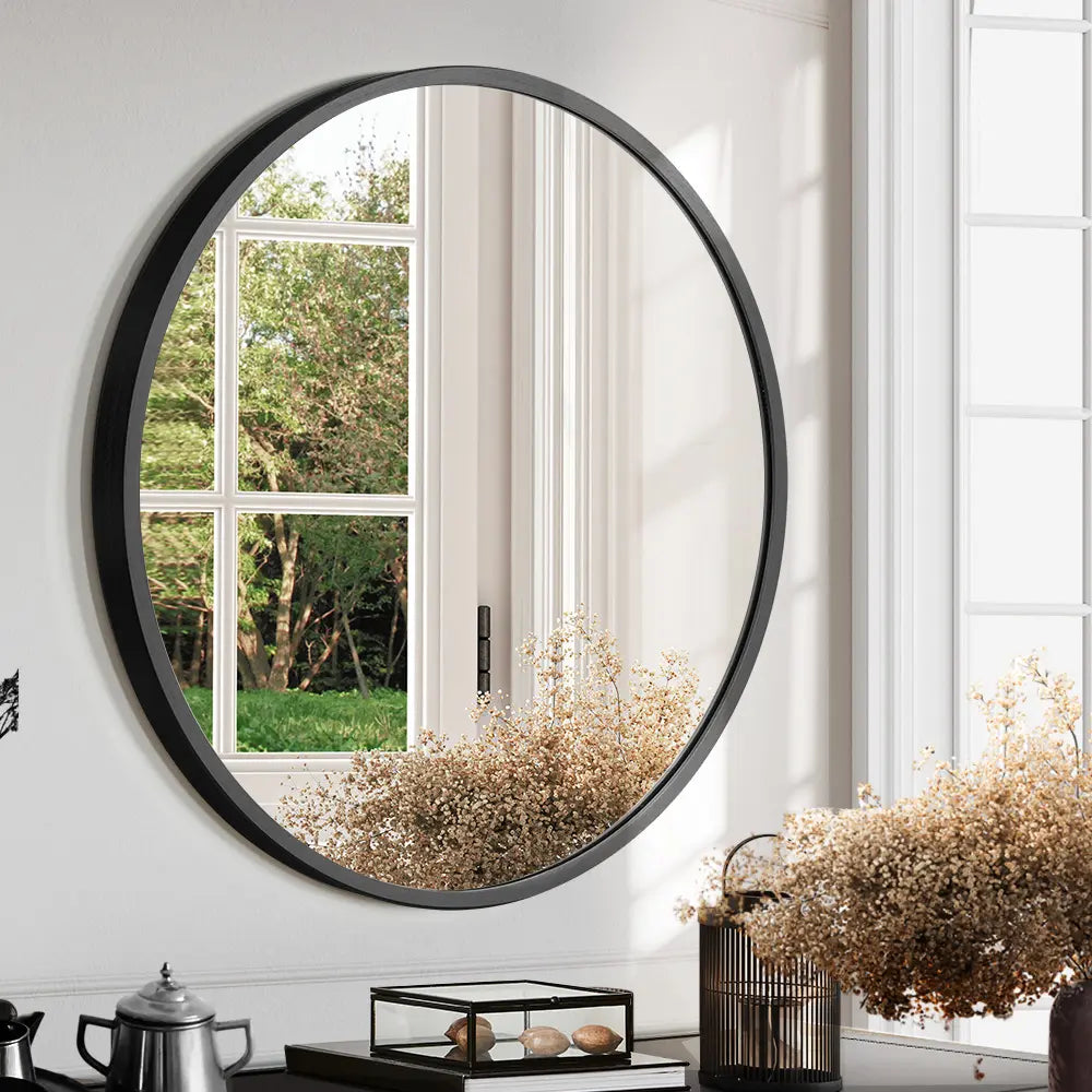 Luna Wall Mirror reflecting natural light in a bright hallway