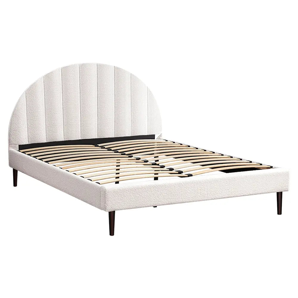 Side view of the Willa Boucle Bed showcasing the padded headboard and sleek frame