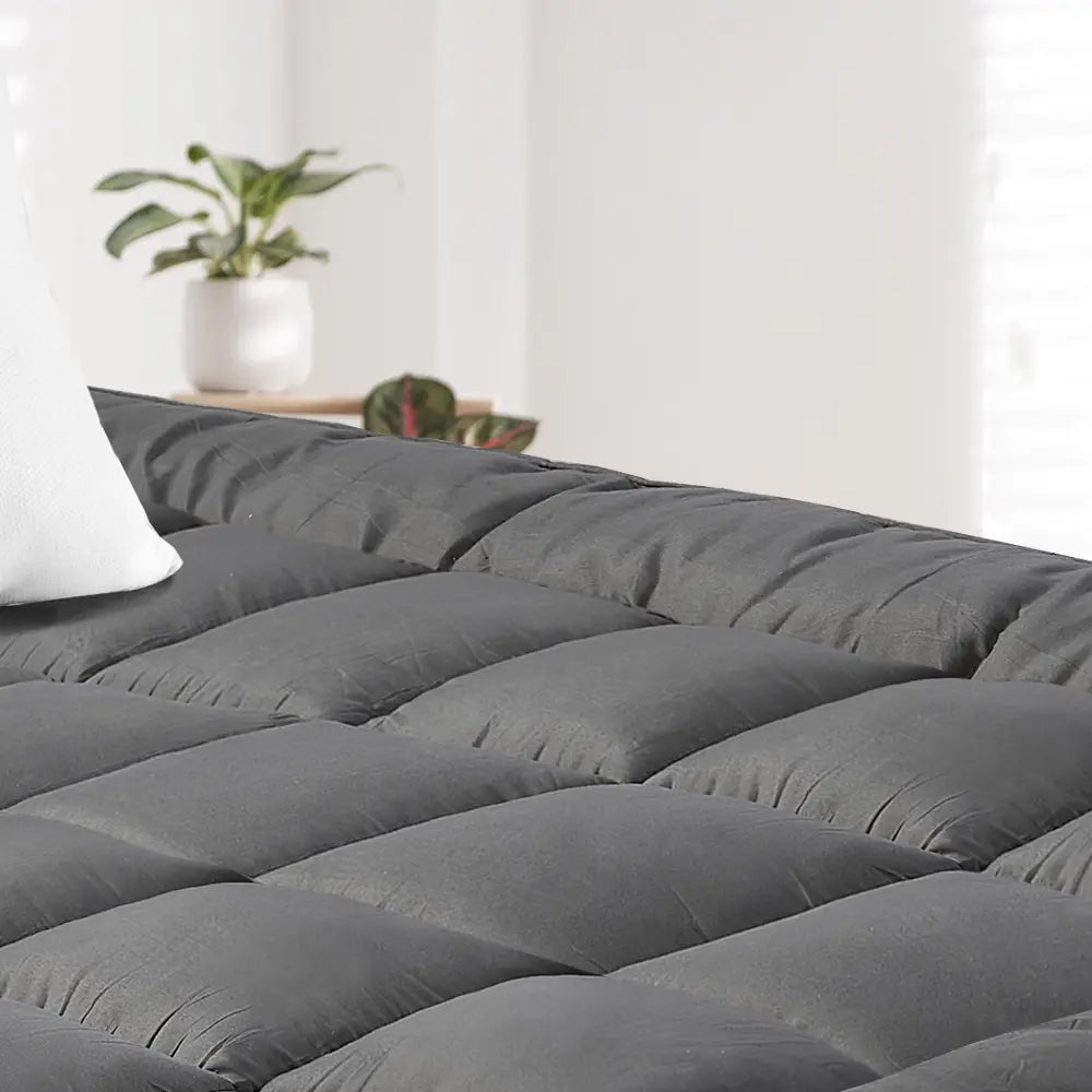 Elastic straps securing the Zoilo Cotton Mattress Topper on a mattress