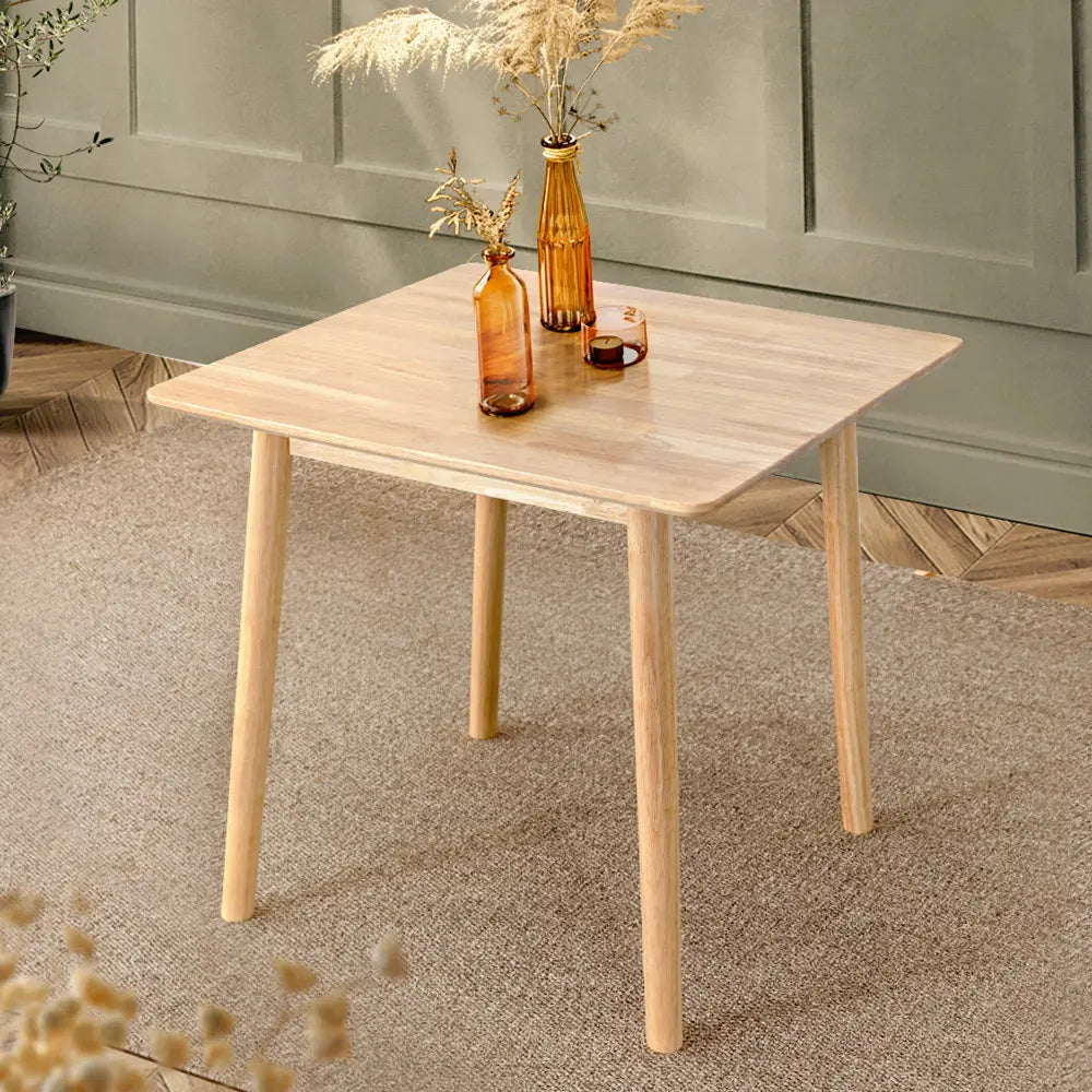Compact square Barron table with natural wood finish in small dining space