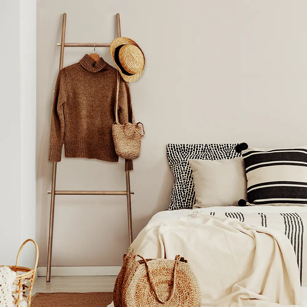 Side view of Docksta towel ladder rack leaning against wall